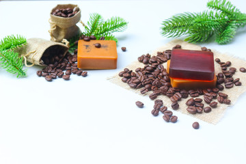Handmade glycerin soap bars with roasted coffee beans on white background