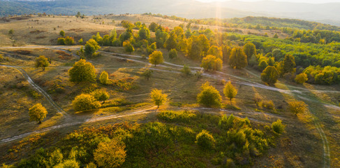 Beautiful sunset over autumnal landscape seen from a drone. Wanderlust concept. 