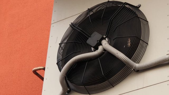 External block of the powerful industrial conditioner.  air conditioning fan ventilation. Air conditioner unit fan rotating. Cooling fan on the wall of a Mercedes factory in Russia