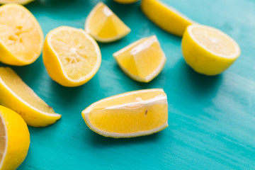Fototapeta na wymiar Pile of fresh lemons on turquoise wooden table.