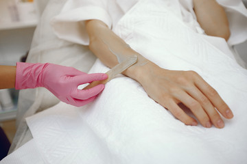 Obraz na płótnie Canvas Hair removal. Gel for laser. Woman in a pink gloves.