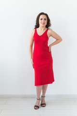 Girl posing on a white room. Fashion style studio portrait. Elegant fashionable woman.