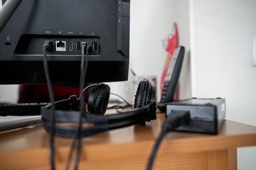 Concept of clutter in office. Unwound and tangled electrical wires under the table. 5S system of...