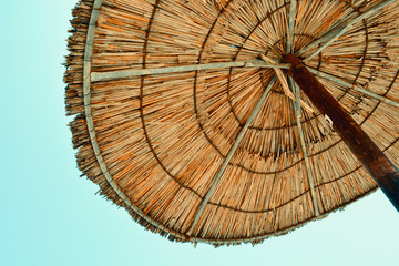 Rustic Wooden Beach Umbrella on a Clear Blue Sky