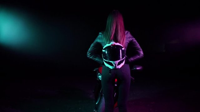 Sexy Girl on a sports bike in a neon light.Night racer.Neon concept