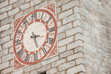 Fototapeta na wymiar The clock painted and recently restored outside the bell tower of the church in Tiso.