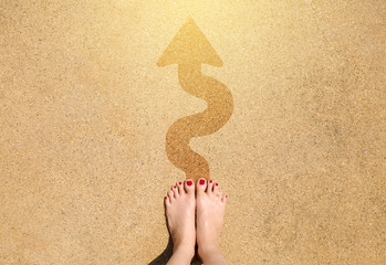 Feet and arrow sign go straight on sea beach background. Top view of woman and barefoot. Selfie...