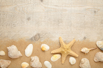 Fototapeta na wymiar Starfish and seashells with sand on light background. Summer concept