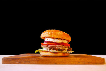 fresh hamburger with cheese meat greens and tomato