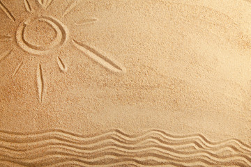 Fototapeta na wymiar Drawing of the summer sun on a sandy beach with copy space. View from above