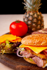 fresh hamburger with cheese meat greens and tomato