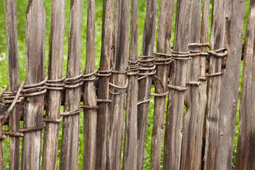 Wooden fence from a green pasture in Val di Funes in Italy