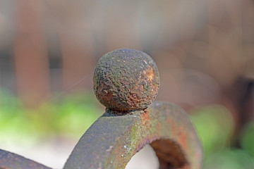 metallic red elements of the old fence