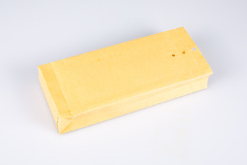 Kraft brown paper square perforated closure envelope on white background