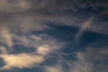 Fototapeta na wymiar Blue sky background with big tiny stratus cirrus striped cloud before storm.