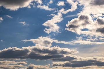 Obraz premium Blue sky background with big tiny stratus cirrus striped cloud before storm.