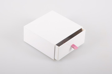 Opened cardboard sliding box with drawer pink ribbon