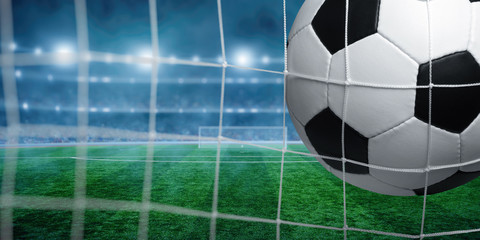 Soccer ball in goal on stadium