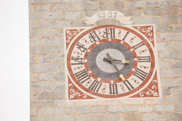 The clock painted and recently restored outside the bell tower of the church in Tiso..