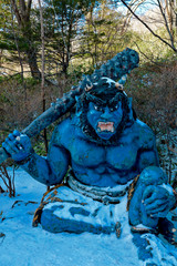 Giant statue in front of Jigokudani or Hell Valley area at Noboribetsu Onsen town on winter. 