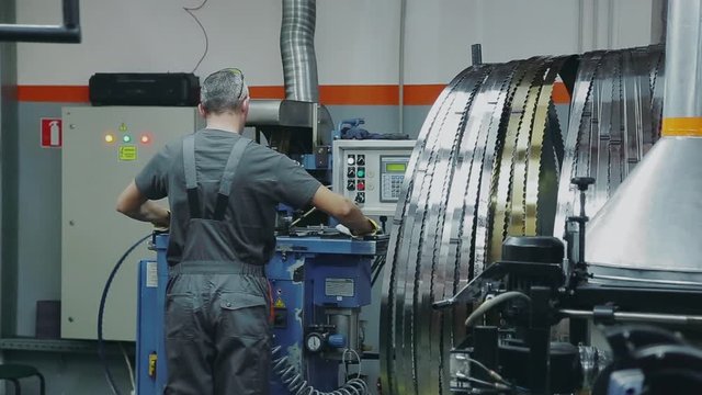 Welding the band saw blade on a automated machine,, close-up shot, sparks fly.