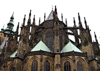 Fototapeta na wymiar Prague, Czech Republic - 28 December 2019: Exterior details of St. Vitus Cathedral, a gothic religious building with towers, spires and mosaic decorations