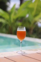 Cold Beer In Glass With Green Background.