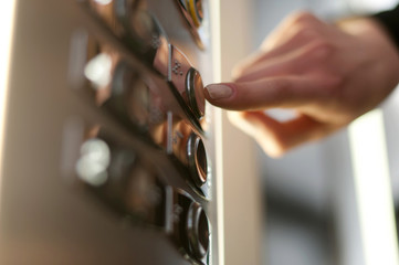 female hand presses a button in the elevator