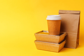 Takeaway food concept. Some packed food in container with coffee cup on table