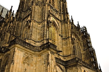 Fototapeta premium Prague, Czech Republic - 28 December 2019: Exterior details of St. Vitus Cathedral, a gothic religious building with towers, spires and mosaic decorations
