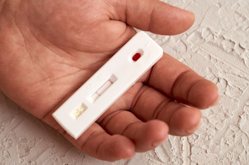 Self-testing of blood for viruses. The girl checks herself