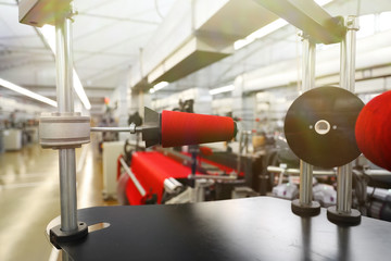 Close-up of the produced threads against the background of the production line. Factory for the production of threads and fabrics