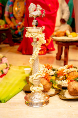 Traditional silver oil lamp burning at a South-Indian Hindu wedding