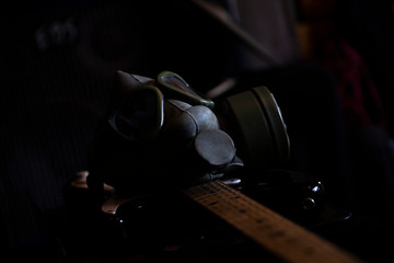 Military Gas Mask on a electric guitar in dark ambient. Coronavirus, Covid19 pandemic prevention. Toxic, biohazard and infection danger. Apocalyptic musicology concept