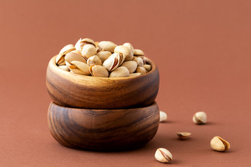 Pistachio nuts in a wooden plate.Healthy nutrition. Food Vegetarian.
