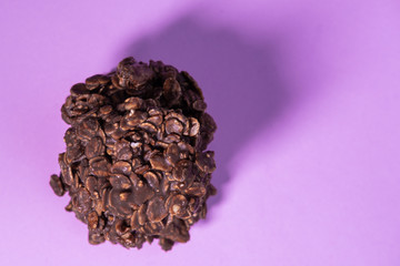 Oatmeal cookies on pink background made with chocolate powder and peanut butter. Healthy and homemade snack. Top view.