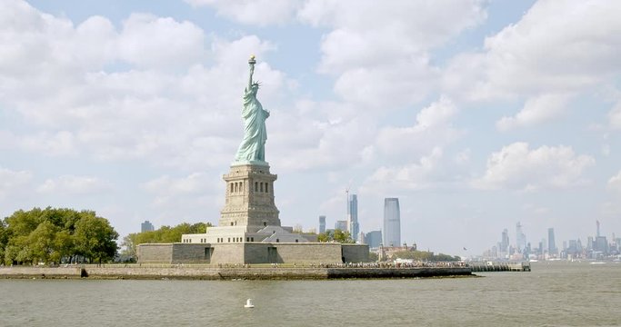 The famous Statue of Liberty on Liberty Island, Manhattan, against the New York City skyline.