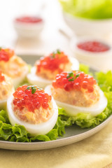 Stuffed eggs with red caviar.