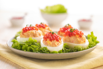 Stuffed eggs with red caviar.