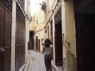 Fototapeta na wymiar A woman walks through the medina, Fez, Morocco
