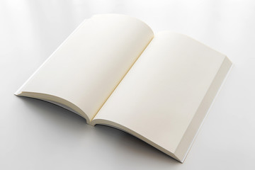 Blank opened book on white paper background