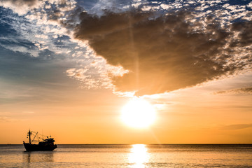 Fototapeta na wymiar Lonely boat in the ocean by sunset