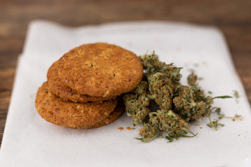 Cookies with CBD marijuana close to cannabis buds.