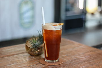 Iced Tea glass of beer on wooden table.