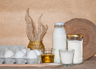 ingredients for dough and baking prepearing pancakes ,flitters,dumplings, vareniks from eggs,flour,milk,salt,sugar and eggs