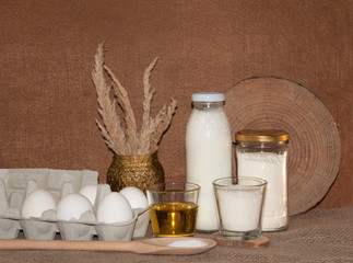 ingredients for dough and baking prepearing pancakes ,flitters,dumplings, vareniks from eggs,flour,milk,salt,sugar and eggs