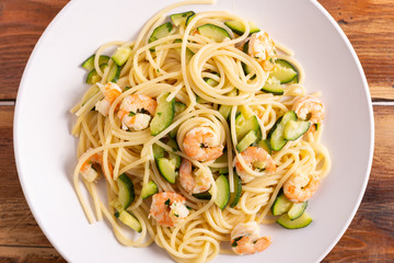 Spaghetti with shrimps and zucchini. Typical dish on italian cuisine. Summer lunch.