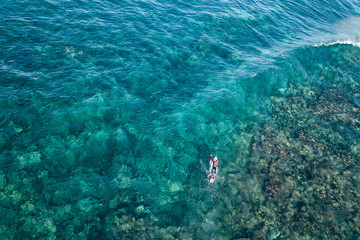 surfing in ocean aerial view