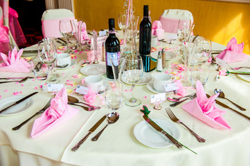 Table set for a Wedding reception with bottles of wine