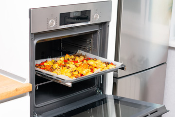 Cooking in the kitchen in the electric oven. Electric oven with hot air ventilation. New oven. Cooking at home